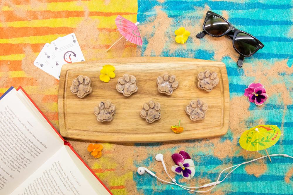 paw shaped treats on a wooden board