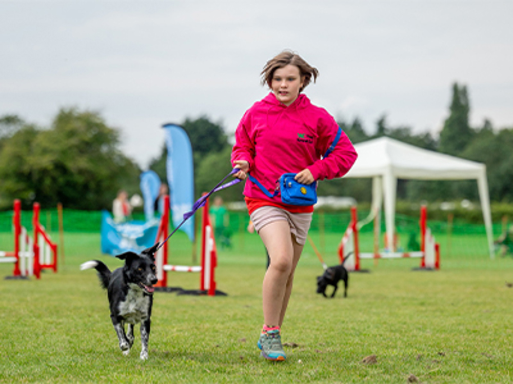 YKC member running with dog 